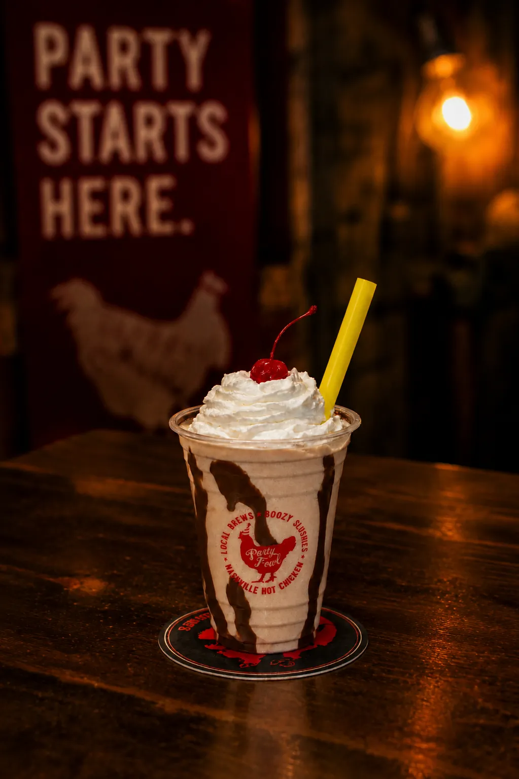 Bushwacker A Bushwacker cocktail topped with whipped cream and a cherry, served in a branded cup with a yellow straw