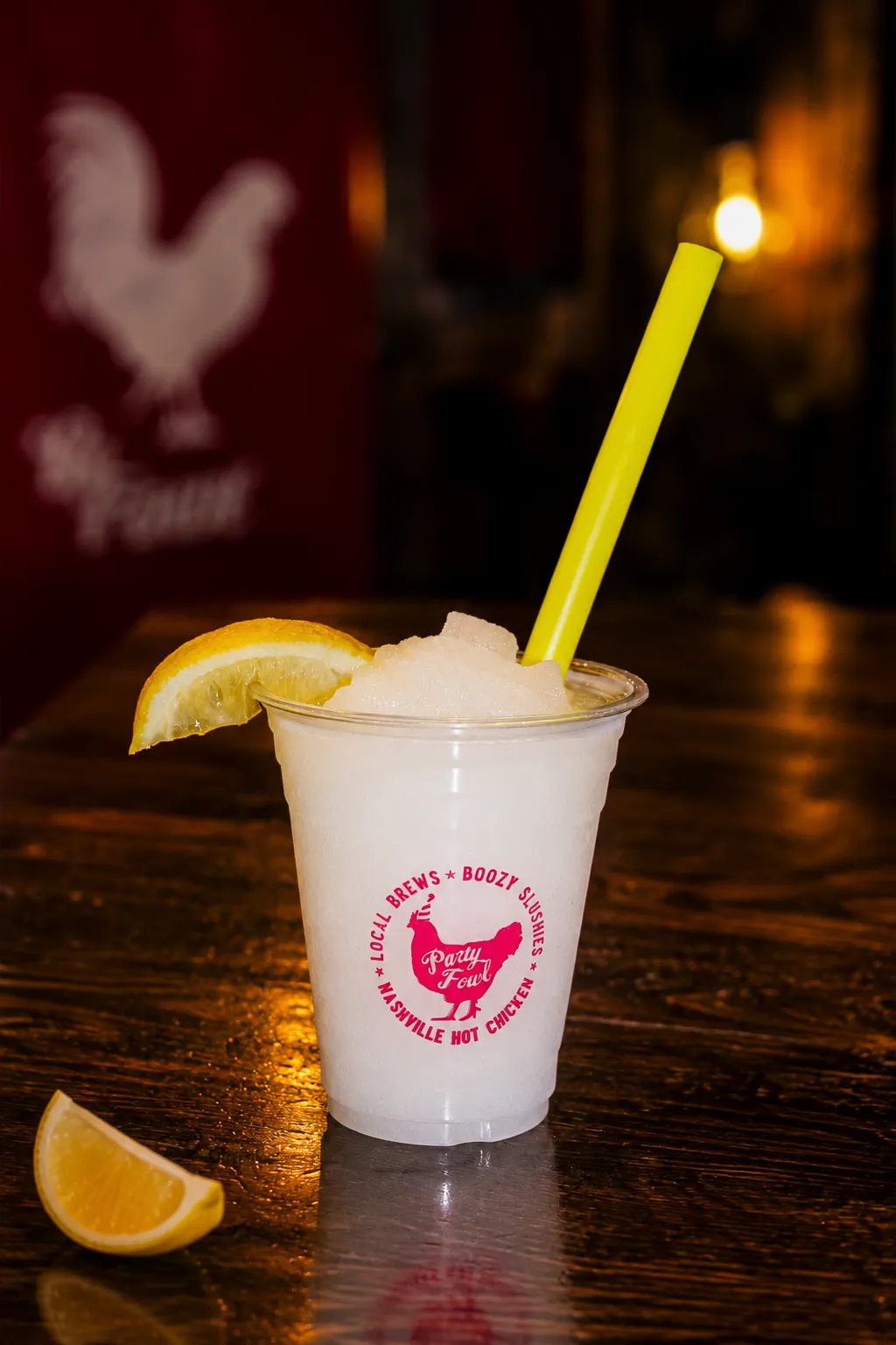 Lemonade A refreshing lemonade with a lemon slice and a yellow straw, served in a branded cup.